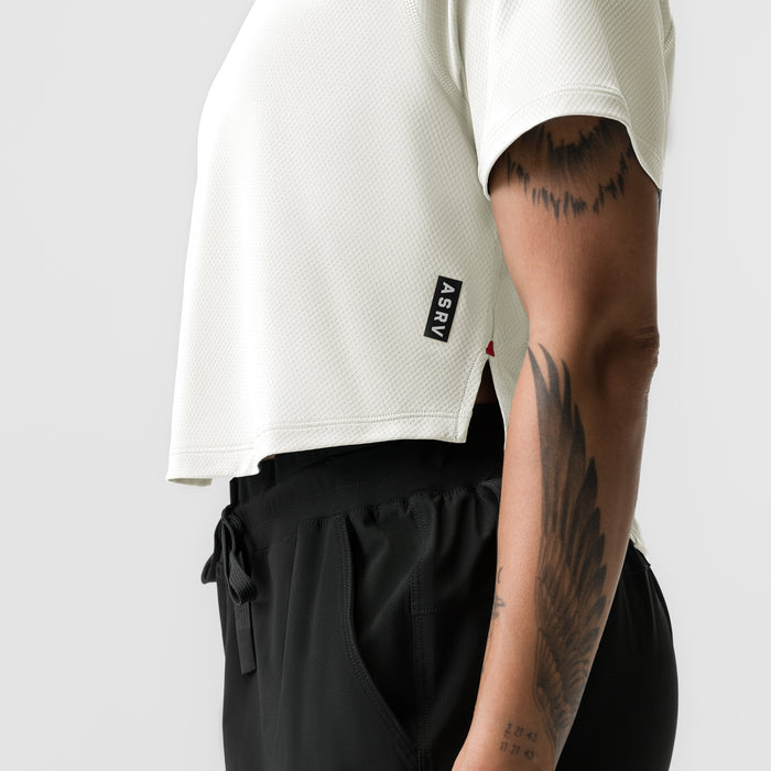 ASRV AeroSilver Cropped Training Tee in ivory cream worn by model, side view