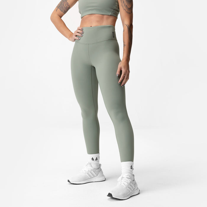 Sage green 7/8 legging worn with white sneakers, front-side view