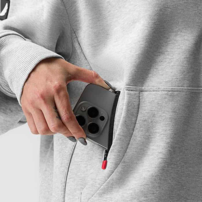 Heather grey oversized zip hoodie worn by model, hand in pocket detail shot