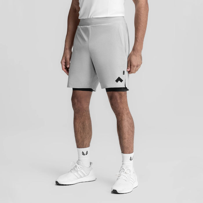 Slate grey bonded liner shorts with black trim on model wearing white sneakers, front view