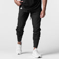 Black High Rib Jogger worn by model with white sneakers, front view