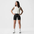 Ivory cream cropped training tank on model, paired with black shorts and white socks, front facing