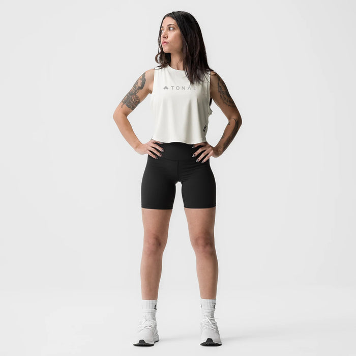 Ivory cream cropped training tank on model, paired with black shorts and white socks, front facing