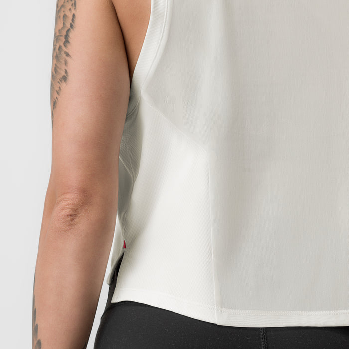 Ivory cream cropped training tank on model, side view showing fit and tattooed arm