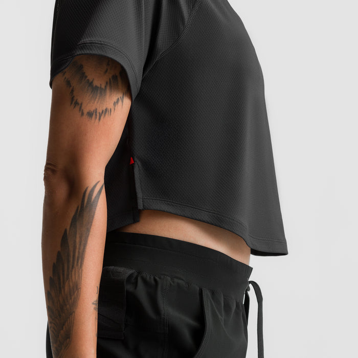 Black AeroSilver cropped training tee on model, side view showing fit and tattoos