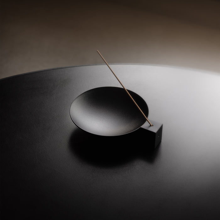 flatlay of ASRV x Walden Block Incense Holder in black, overhead view with incense stick