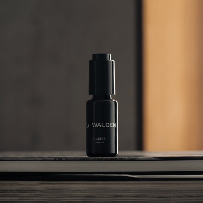 flatlay of ASRV x Walden Forest Essential Oil in black, front view