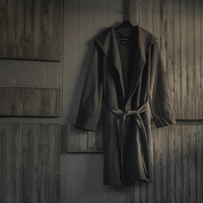ASRV Heavyweight Robe in carbon, hung on hanger against wooden wall