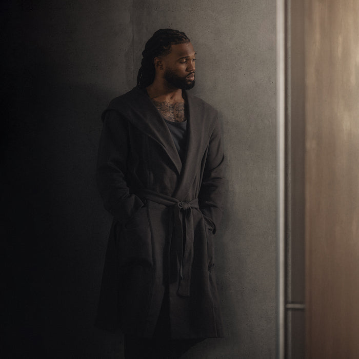 ASRV x Walden Heavyweight Robe in Carbon, worn by model against concrete wall