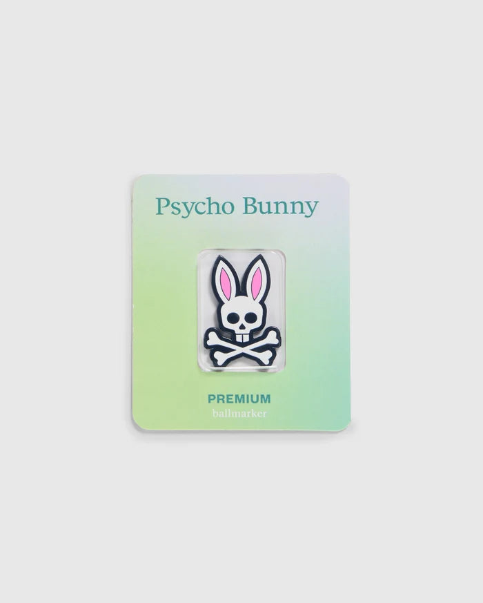 Explore the Psycho Bunny golfers collection with this premium ball marker featuring a white skull with pink bunny ears. Attached to a gradient card transitioning from light green to light blue, it showcases "Psycho Bunny" at the top and "PREMIUM BALL MARKER - B6A698C200" at the bottom.