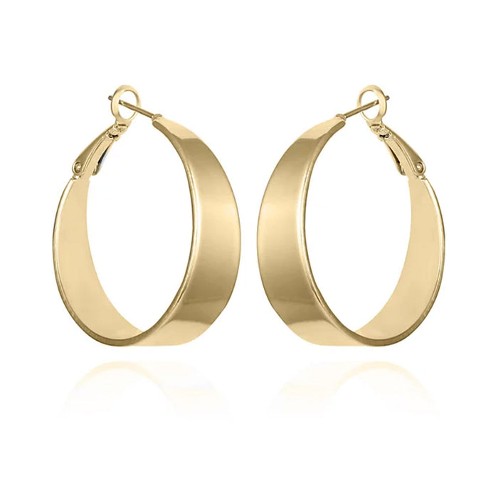 The Vince Camuto Band Thick Hoop Earrings feature classic gold-tone, wide smooth bands with latch-back clasps, shown against a white background.