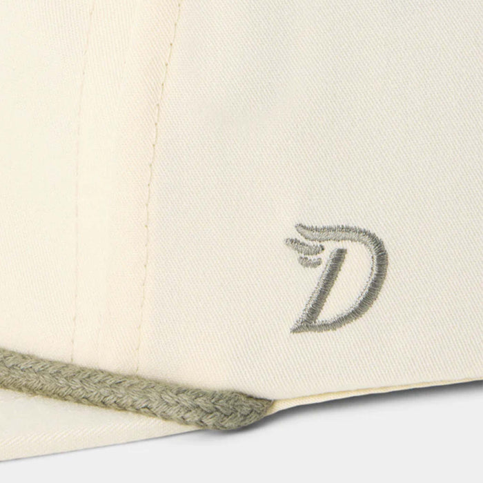 Close-up of a beige cap with a logo on a white background