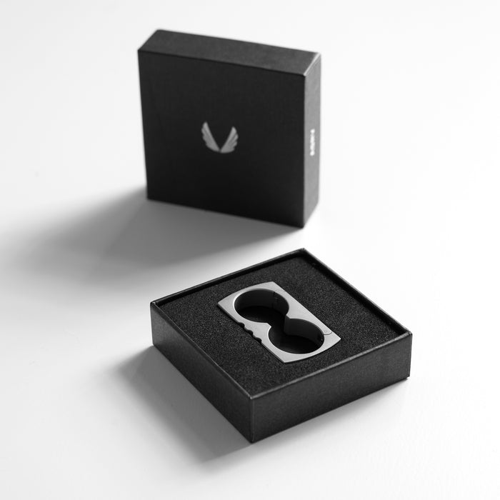 flatlay Carabiner Double Ring in stainless steel and black, displayed in open black box