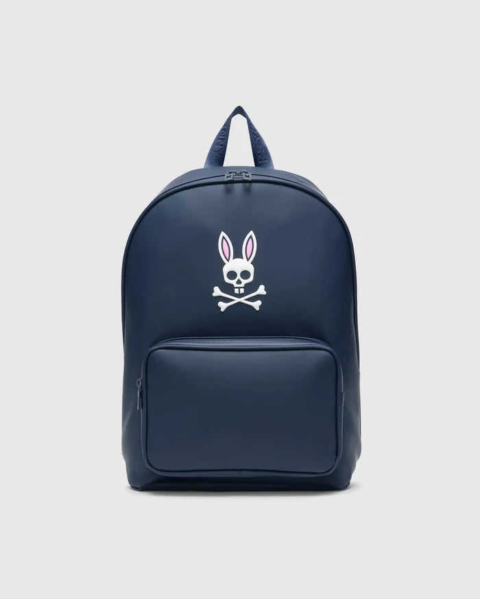 Classic Bunny Backpack in navy blue, featuring a large white Psycho Bunny skull logo with pink ear outlines centered on the front, a smooth texture, and a zippered front pocket.