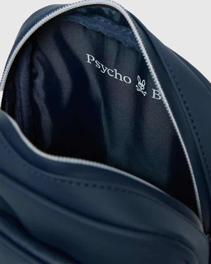 Classic Bunny Messenger Bag in navy blue with a white zipper, featuring a smooth exterior and a textured interior lining with a large white Psycho Bunny skull logo.