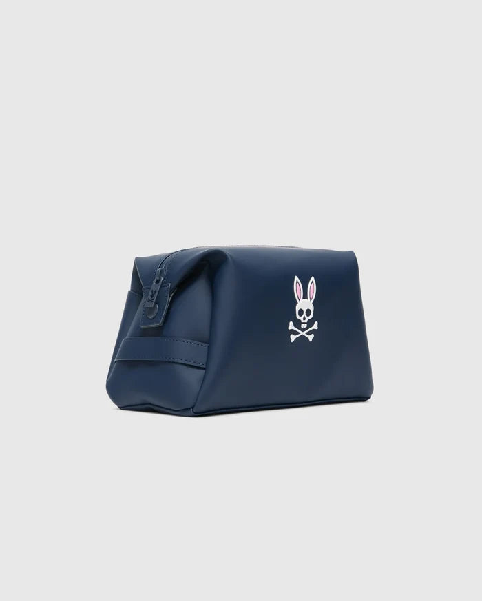 Psycho Bunny Classic Bunny Toiletry Kit in smooth navy blue, with a top zipper and prominent white and pink embroidered skull logo.