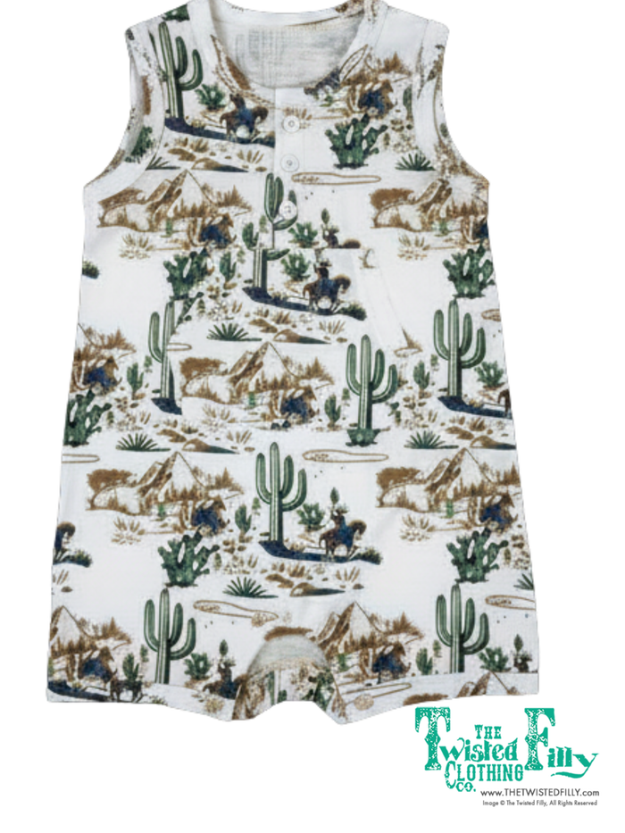 Children's romper with desert-themed print on a white background, featuring cacti, horses, and cowboys.