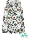 Children's romper with desert-themed print on a white background, featuring cacti, horses, and cowboys.