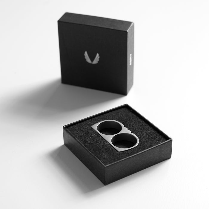 flatlay Double Ring stainless steel in silver and black, top view in packaging