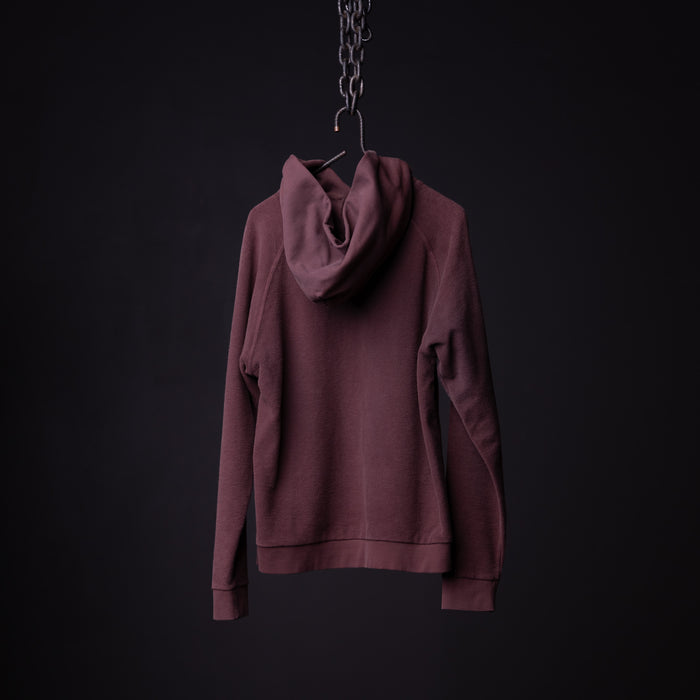 Burgundy reverse weave hoodie displayed on hanger against dark background, back view