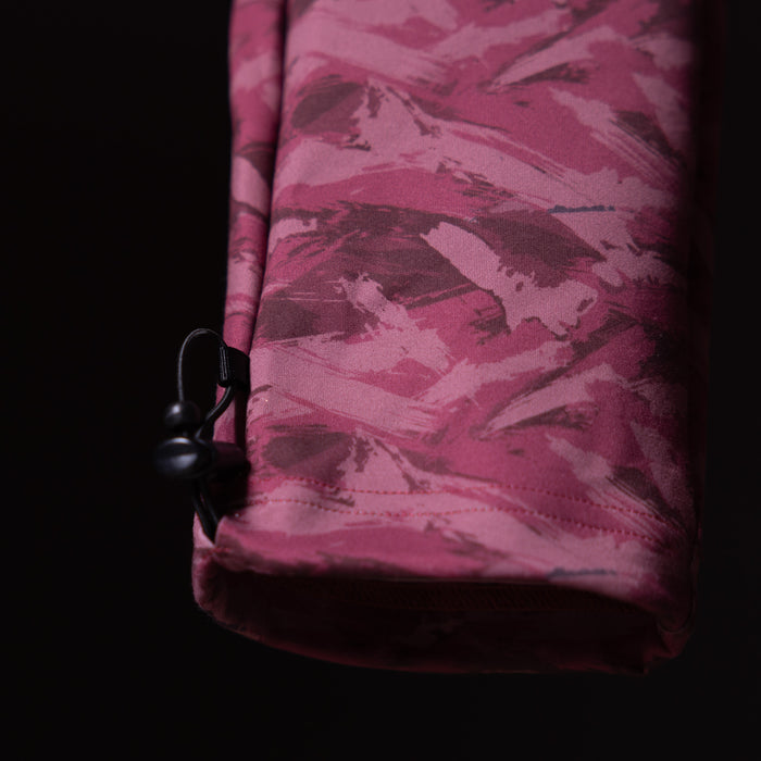 Brushed camo cargo jogger in burgundy, held against dark background detail shot