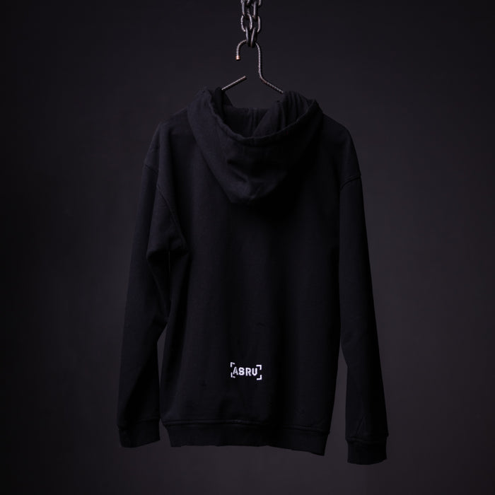 Black distressed hoodie on hanger against dark background, back view showing logo