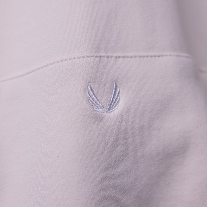 Tech Terry Eagle Hoodie detail closeup showing embroidered wing logo on light purple fabric