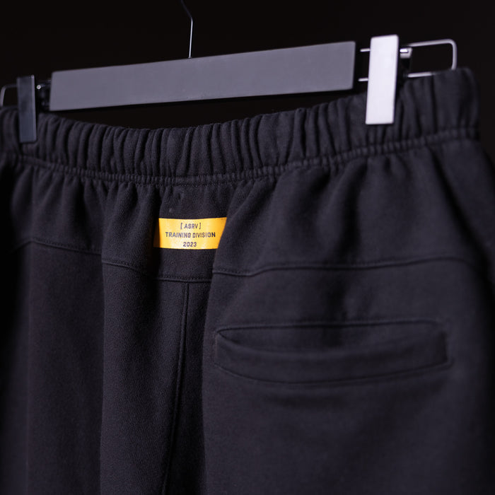 FA'23 Straight Leg Jogger in black, displayed on hanger with yellow Training Division label visible