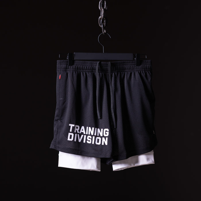 flatlay FA'23 Training Division Mesh Shorts in black and white, front view on hanger