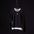 Black Terry Crew Neck sweatshirt with white trim displayed on hanger against dark background