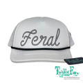 White trucker cap with 'Feral' embroidery and brand tag on a white background