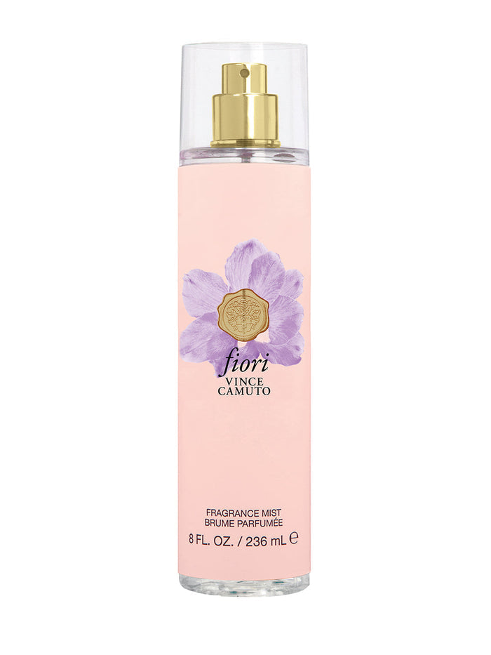 A pink 8.0 oz bottle of Vince Camuto Fiori Body Mist features a gold spray top and a purple flower graphic on the label. This women’s fragrance mist offers a fresh and delicate floral scent.