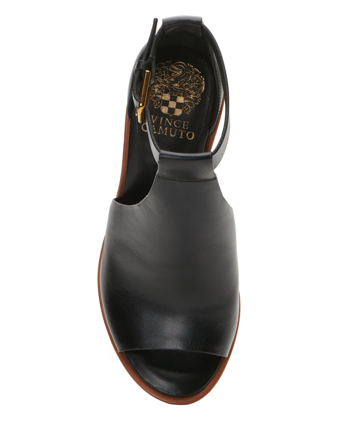 Black leather Frasper Shootie by Vince Camuto featuring a T-strap design, open toe, and slingback strap with a gold buckle, shown in an overhead view. The cushioned footbed is detailed with a gold Vince Camuto logo and decorative accents on the insole.