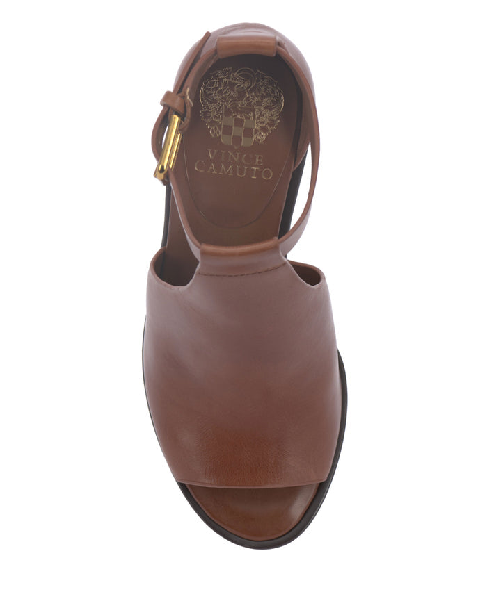 Frasper Shootie by Vince Camuto shown from above, featuring brown leather T-strap design with open toe, ankle strap, and gold buckle. The cushioned footbed provides added comfort, while the insole is adorned with the Vince Camuto branding and a decorative gold emblem.