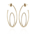 Vince Camuto Goldtone Crystal Stone Orbital Hoop Earrings feature an inner oval ring embellished with sparkling crystal stones, suspended inside a larger open goldtone oval frame, and are displayed against a white background.