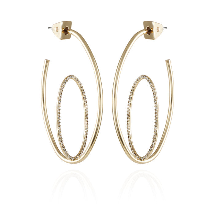 Vince Camuto Goldtone Crystal Stone Orbital Hoop Earrings feature an inner oval ring embellished with sparkling crystal stones, suspended inside a larger open goldtone oval frame, and are displayed against a white background.