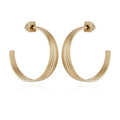 A pair of Goldtone Open Stacked Hoop Earrings by Vince Camuto, featuring a large, ridged design with squared backs, displayed against a white background—an elegant addition to any jewelry collection.