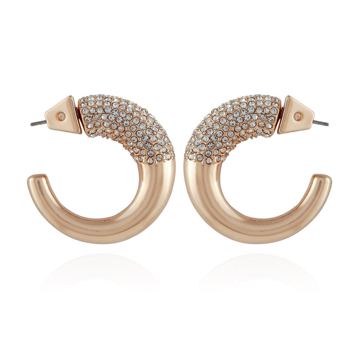 A pair of Vince Camuto Goldtone Pave Crystal Stone Open Hoop Earrings, each featuring one half adorned with shimmering pave crystals and the other half smooth and polished. The earrings are displayed facing each other on a white background.