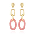 Introducing the Vince Camuto Goldtone Pink Candy Interlocking Drop Earrings, featuring oval studs, elongated chain links, and large pink oval hoops at the bottom. These chic earrings make a standout addition to any jewelry collection and are beautifully displayed on a white background.