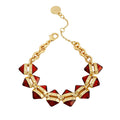Introducing the Goldtone Red Stone Cable Chain Bracelet by Vince Camuto—a chic accessory showcasing geometric red resin stone accents along a gleaming gold cable chain. Designed with a secure lobster clasp, the bracelet also features an adjustable extender chain adorned with a round gold charm at the end.