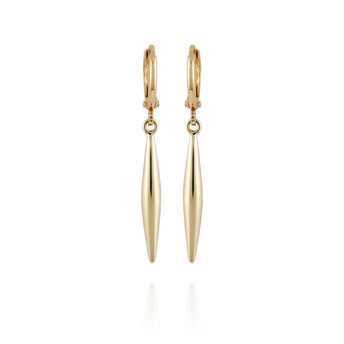 The Vince Camuto Goldtone Spear Dangle Huggie Hoop Drop Earrings feature elongated, tapered pendants that hang vertically from polished gold huggie hoops. These elegant earrings have a smooth, shiny finish and are beautifully presented against a plain white background.