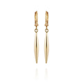 The Vince Camuto Goldtone Spear Dangle Huggie Hoop Drop Earrings feature elongated, tapered pendants that hang vertically from polished gold huggie hoops. These elegant earrings have a smooth, shiny finish and are beautifully presented against a plain white background.