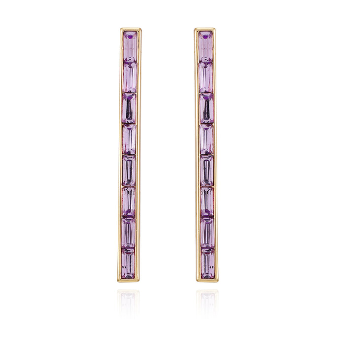 The Goldtone Violet Stone Baguette Stick Drop Earrings by Vince Camuto feature a modern linear design with a vertical row of baguette-cut purple stones, elegantly displayed on a white background.