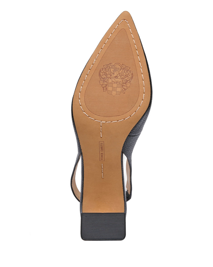 The bottom view of the Vince Camuto Hamden Slingback displays a tan sole with visible stitching, a small heel, and an embossed crest design near the toe area beneath its black leather point-toe upper.
