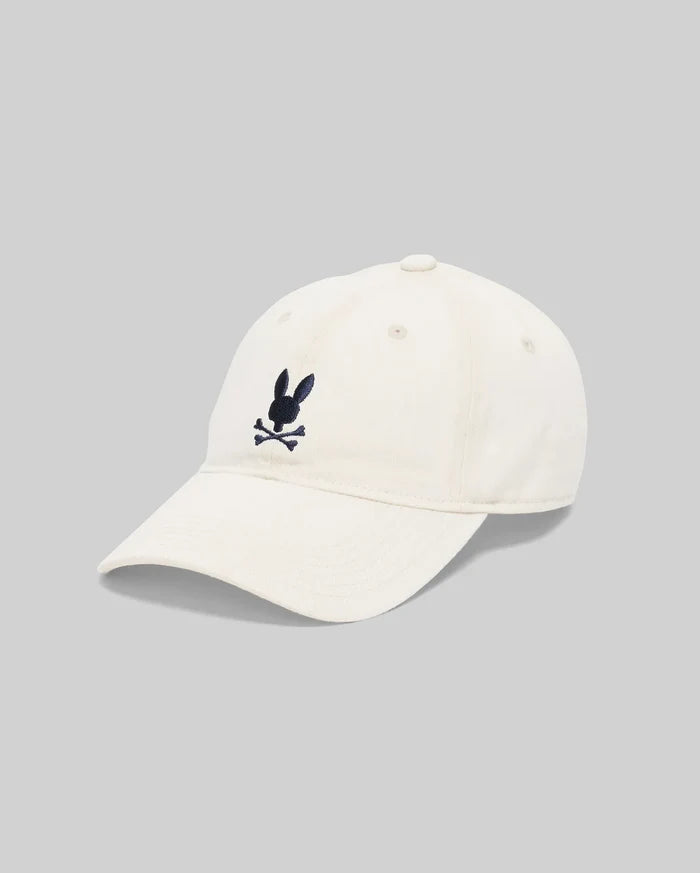 Jimmy Baseball Cap in cream cotton twill, featuring a classic fit and a medium-sized, embroidered navy blue Psycho Bunny skull logo centered on the front.