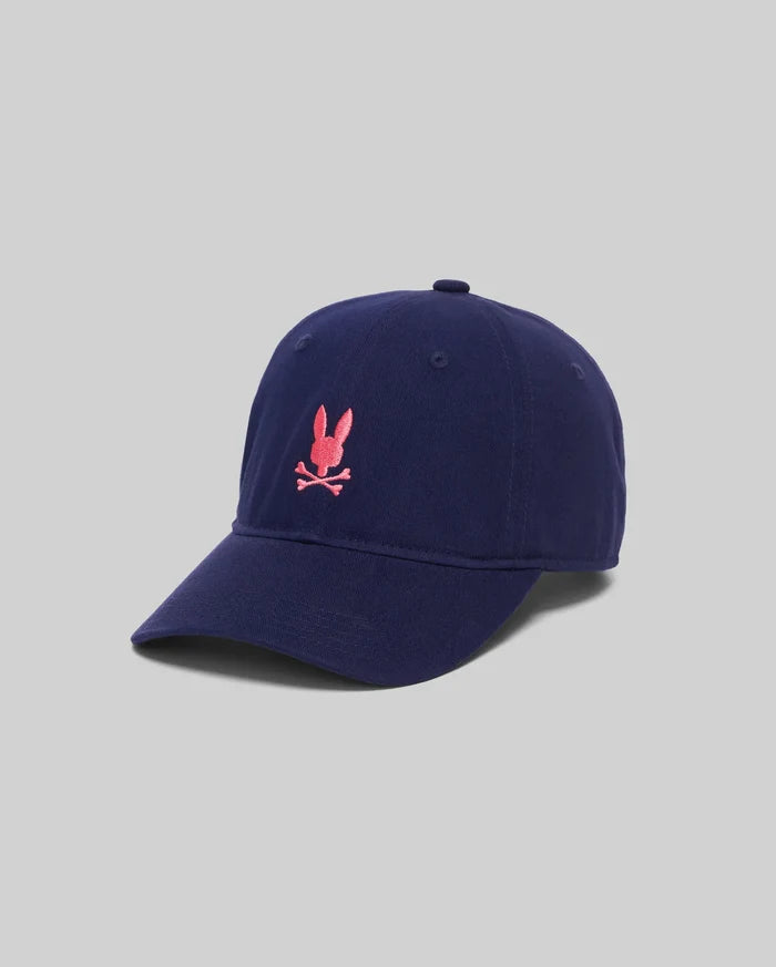 Mens Jimmy Baseball Cap, a navy cotton twill hat with a classic fit, featuring a vibrant pink embroidered Psycho Bunny skull logo prominently centered on the front.