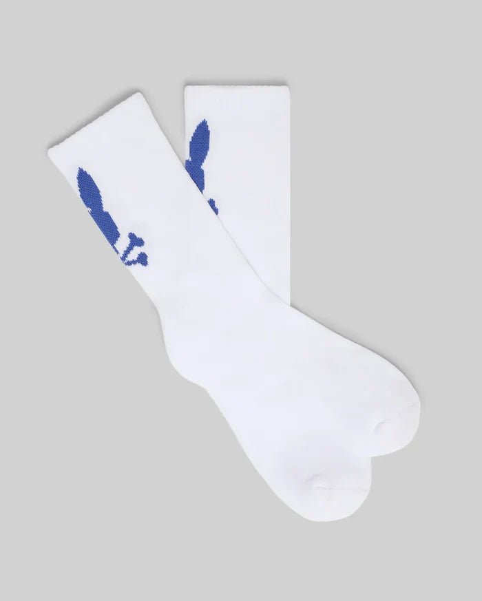 White Kids 3 Pack Sport Socks, featuring a soft knit texture and crew length. Each sock displays a medium-sized blue knitted Psycho Bunny skull logo on the mid-calf.