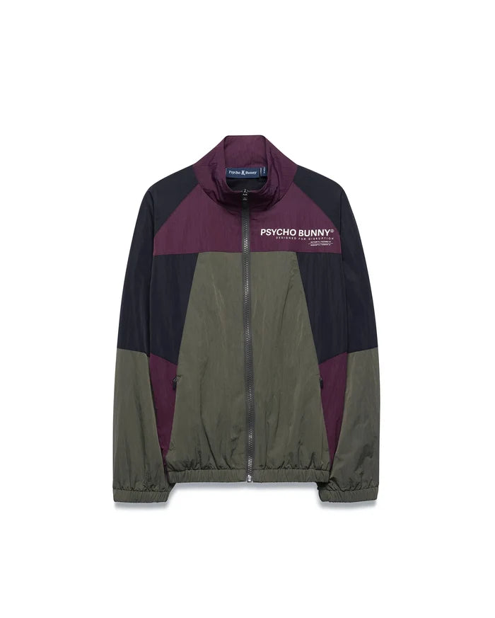 Kids Alder Nylon Colorblock Jacket in olive green, black, and deep purple, featuring a full zip, stand collar, and large white Psycho Bunny chest logo with Designed For Disruption text. Relaxed fit, crinkled nylon.