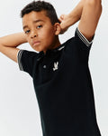 Kids Brad Pique Polo, a classic black pique polo shirt with a two-button placket, ribbed collar, and double white striped sleeve cuffs, featuring a small embroidered silver Psycho Bunny skull logo on the left chest.