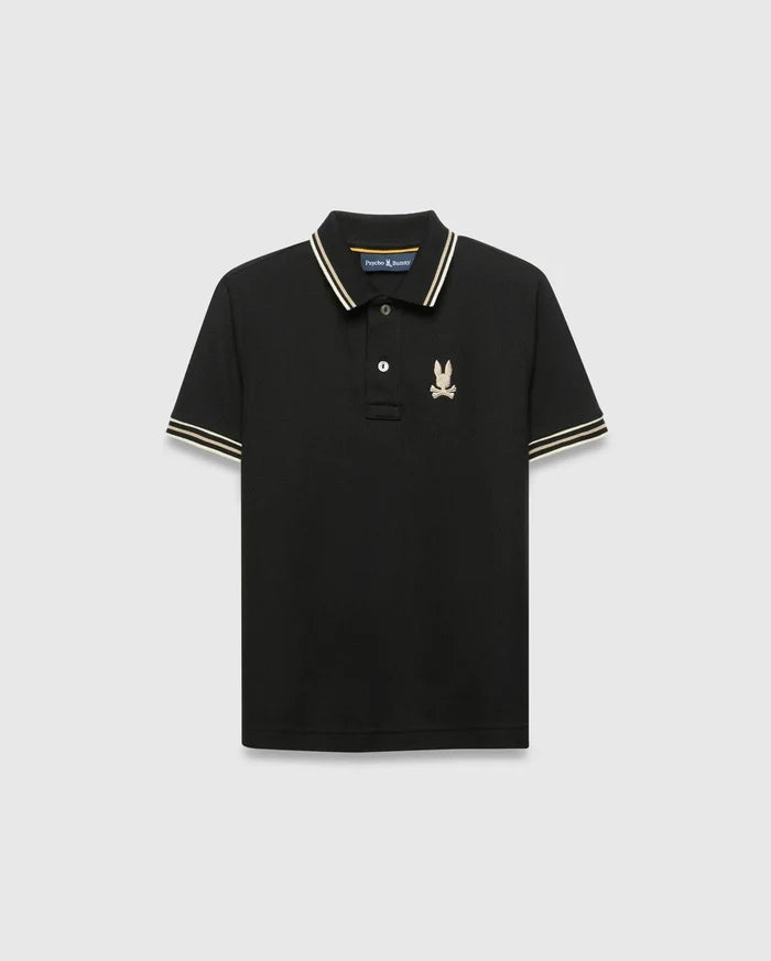 Kids Brad Pique Polo, black classic fit pique knit with gold-tan and white striped collar and cuffs, featuring a small embroidered gold Psycho Bunny skull logo on the left chest.